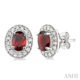 7x5mm Oval Cut Garnet and 3/8 Ctw Round Cut Diamond Earrings in 14K White Gold